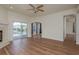 A spacious living room with wood floors, fireplace, and sliding doors to the pool at 1246 Ocean Reef Rd, Wesley Chapel, FL 33544