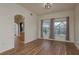 An open-concept living area with wood floors and large windows offering lots of natural light at 1246 Ocean Reef Rd, Wesley Chapel, FL 33544
