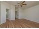 A spacious main bedroom with wood floors and access to an ensuite bathroom at 1246 Ocean Reef Rd, Wesley Chapel, FL 33544