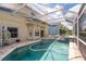 Large pool with a screened lanai, brick paver deck and attached spa at 1246 Ocean Reef Rd, Wesley Chapel, FL 33544