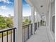 Picturesque balcony showcasing a neighborhood view, black metal railings and architectural columns at 135 Commonwealth N Ct, St Petersburg, FL 33716