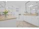 Bright primary bathroom with double vanity, soaking tub, separate glass shower, and modern fixtures at 135 Commonwealth N Ct, St Petersburg, FL 33716