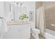 Bathroom with light beige tile, white vanity, matching toilet, and a shower with curtain rod at 135 Commonwealth N Ct, St Petersburg, FL 33716