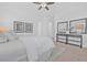 Bright bedroom with neutral decor, ceiling fan, side table with lamps and decorative wall art at 135 Commonwealth N Ct, St Petersburg, FL 33716