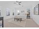 Bright bedroom with neutral decor, ceiling fan, bench seat, and large windows providing plenty of natural light at 135 Commonwealth N Ct, St Petersburg, FL 33716