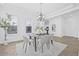 Bright dining area with modern table, elegant chandelier, and large windows; perfect for Gathering gatherings at 135 Commonwealth N Ct, St Petersburg, FL 33716