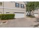Exterior view of a well-maintained garage with a white door and landscaped surroundings at 135 Commonwealth N Ct, St Petersburg, FL 33716