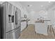 Spacious kitchen with stainless steel refrigerator, white cabinets and granite countertops at 135 Commonwealth N Ct, St Petersburg, FL 33716