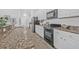 Modern kitchen featuring granite countertops, white cabinets, and stainless steel appliances at 135 Commonwealth N Ct, St Petersburg, FL 33716