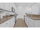 Well-equipped kitchen featuring granite countertops, white cabinetry, and modern appliances at 135 Commonwealth N Ct, St Petersburg, FL 33716