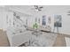 Airy living room featuring a cozy seating arrangement, fireplace, and seamless flow to the dining area at 135 Commonwealth N Ct, St Petersburg, FL 33716