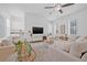 Bright living room with modern decor, ceiling fan, neutral color palette, and stylish furnishings at 135 Commonwealth N Ct, St Petersburg, FL 33716