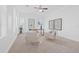 Bright home office with plush chairs, desk, and natural light from large windows at 135 Commonwealth N Ct, St Petersburg, FL 33716
