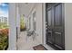 Welcoming porch with seating, elegant columns, and lush landscaping, a perfect spot to unwind at 135 Commonwealth N Ct, St Petersburg, FL 33716