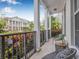 Relaxing porch with seating, iron railing, and vibrant landscaping, offering a pleasant outdoor space at 135 Commonwealth N Ct, St Petersburg, FL 33716