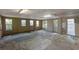 Unfinished basement featuring multiple windows, concrete floor and exposed ceiling framework at 1506 E Poinsettia Ave, Tampa, FL 33612