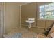 Bathroom with peeling paint, poor flooring and a basic sink at 1506 E Poinsettia Ave, Tampa, FL 33612