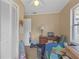 Small bedroom with a desk, closet and carpeted flooring at 1506 E Poinsettia Ave, Tampa, FL 33612