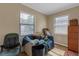 Small bedroom featuring neutral walls, carpeted flooring, and natural light from two windows at 1506 E Poinsettia Ave, Tampa, FL 33612