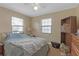 Spacious bedroom featuring neutral walls, carpeted flooring, and natural light from two windows at 1506 E Poinsettia Ave, Tampa, FL 33612