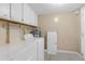 White washer and dryer in dedicated laundry area with ample storage cabinetry above at 1506 E Poinsettia Ave, Tampa, FL 33612