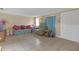 Comfortable living room features tile floors and inviting decor and front door entry at 1506 E Poinsettia Ave, Tampa, FL 33612