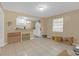 Bright living room area with neutral tiled floors adjacent to kitchen for easy entertaining at 1506 E Poinsettia Ave, Tampa, FL 33612