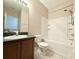 Full bathroom featuring tile floors, shower-tub combo, vanity with dark wood cabinets and gray counters at 15922 Fishhawk Creek Ln, Lithia, FL 33547