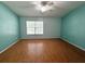 Bright bedroom featuring laminate wood flooring, and blue accent walls at 15922 Fishhawk Creek Ln, Lithia, FL 33547