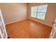 Cozy bedroom with laminate flooring and a large window, perfect for relaxation and rest at 15922 Fishhawk Creek Ln, Lithia, FL 33547