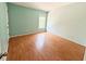 Bright bedroom featuring wood-look floors and a window for natural light at 15922 Fishhawk Creek Ln, Lithia, FL 33547