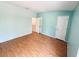 Light-filled bedroom with laminate flooring, blue walls, and ample space at 15922 Fishhawk Creek Ln, Lithia, FL 33547