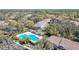 Aerial view of a beautiful community pool area and nearby residential buildings at 15922 Fishhawk Creek Ln, Lithia, FL 33547