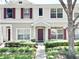 Charming townhouse with landscaped front yard, featuring colorful shutters and a welcoming entrance at 15922 Fishhawk Creek Ln, Lithia, FL 33547