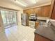 Bright kitchen featuring stainless steel appliances, ample counter space, and access to the screened lanai at 15922 Fishhawk Creek Ln, Lithia, FL 33547