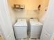 Laundry room equipped with full size washer, dryer, and storage shelves at 15922 Fishhawk Creek Ln, Lithia, FL 33547