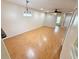 Open-concept living room with laminate wood flooring, ceiling fan, and bright, neutral paint at 15922 Fishhawk Creek Ln, Lithia, FL 33547