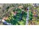 Aerial shot featuring a well-maintained playground with slides, climbing structures, and soft turf at 15922 Fishhawk Creek Ln, Lithia, FL 33547