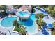 Stunning aerial view of a vibrant pool area, complete with waterfalls and palm trees at 15922 Fishhawk Creek Ln, Lithia, FL 33547