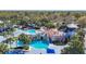 Beautiful pool with a slide and waterfall feature amidst lush landscaping and palm trees at 15922 Fishhawk Creek Ln, Lithia, FL 33547
