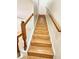 A view looking up the beautiful hardwood staircase with white banisters to the upper level at 15922 Fishhawk Creek Ln, Lithia, FL 33547