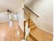 Hardwood staircase with white banisters leading to the upper level of the home at 15922 Fishhawk Creek Ln, Lithia, FL 33547
