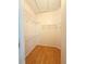 Spacious walk-in closet featuring wood-look floors and built-in shelving at 15922 Fishhawk Creek Ln, Lithia, FL 33547