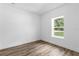 Clean bedroom with wood-look floors and ample natural light through the window at 16247 Little Auk Rd, Weeki Wachee, FL 34614