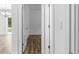 Bright hallway with modern flooring looking towards a room featuring a chandelier at 16247 Little Auk Rd, Weeki Wachee, FL 34614
