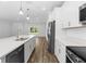 Bright kitchen with stainless steel appliances, a large island, and wood floors at 16247 Little Auk Rd, Weeki Wachee, FL 34614