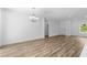 Open-concept living room featuring wood floors and abundant natural light at 16247 Little Auk Rd, Weeki Wachee, FL 34614