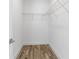 Bright walk-in closet with white shelving and wood-look flooring at 16247 Little Auk Rd, Weeki Wachee, FL 34614