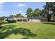 Expansive backyard featuring a screened pool, manicured lawn, and a charming patio area perfect for outdoor entertaining at 16315 Lonely Ln, Odessa, FL 33556