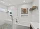 Well-lit bathroom with a modern shower, and a tub, complete with decorative mosaic tiling and modern finishes at 16315 Lonely Ln, Odessa, FL 33556